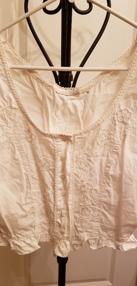 White, sleeveless crop top thst laces up the back.